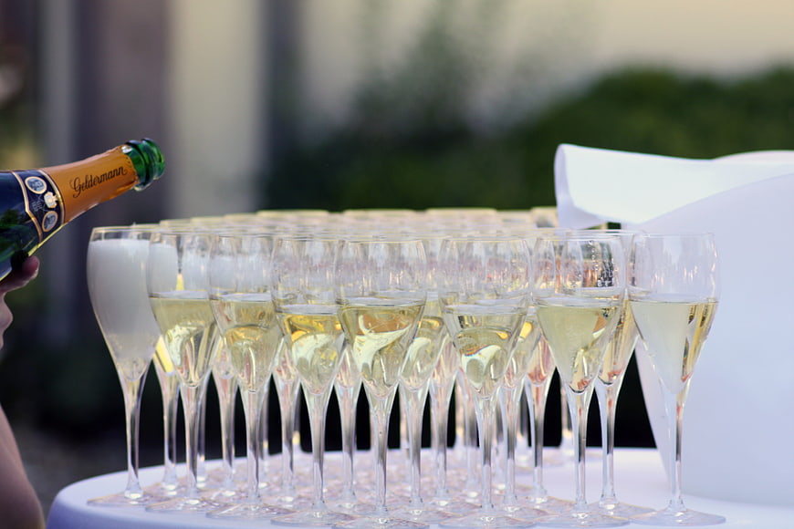Champagne Tower Being Filled at Outdoor Wedding Celebration