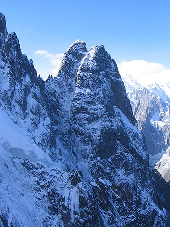 Majestic Snow-Capped Mountain Peak Under Blue Sky
