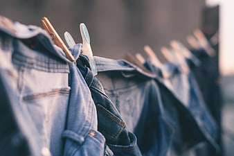 Denim Jeans Hanging on Clothesline with Wooden and Plastic Clips