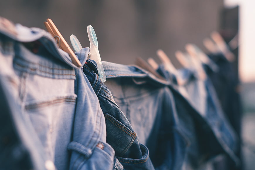 Denim Jeans Hanging on Clothesline with Wooden and Plastic Clips