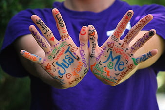 Hands with colorful positive affirmations and self-love messages