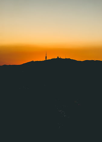 Silhouette of Mountain Peak with Tower at Sunset