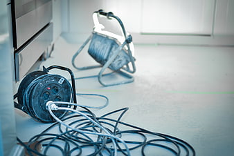 Construction site power cable reel and work light on floor