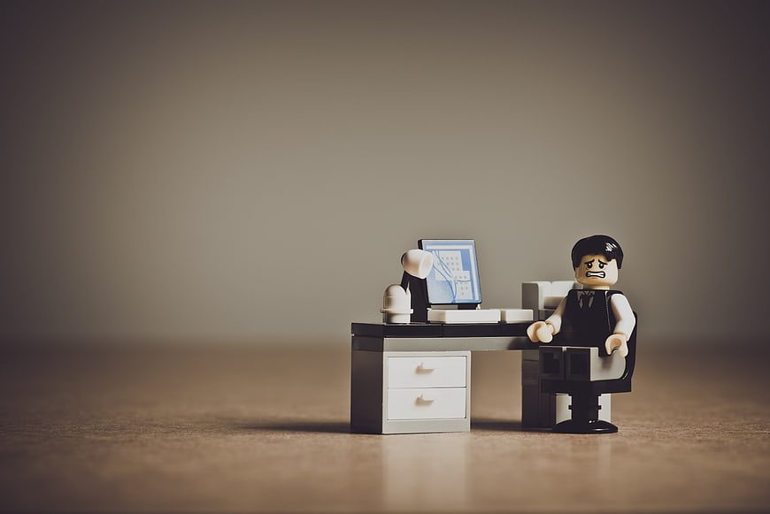 Sad Lego Businessman at Office Desk