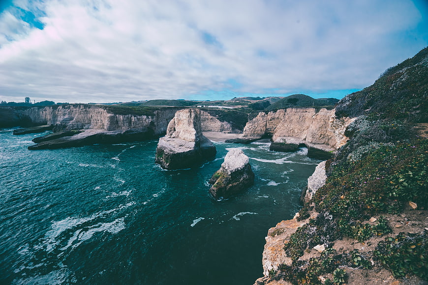 Dramatic coastal cliffs and sea stacks with turquoise ocean waves