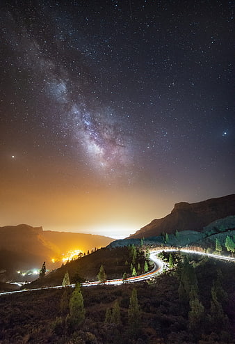 Milky Way Over Mountain Road With Light Trails At Night