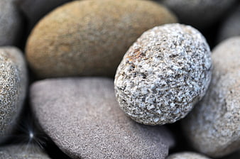 Close-up of textured smooth river stones and pebbles
