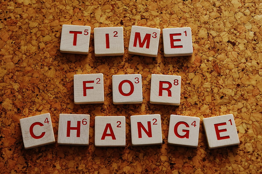 Scrabble Tiles Spelling Time For Change on Cork Board