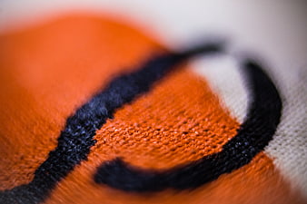 Macro shot of orange and black knitted fabric texture