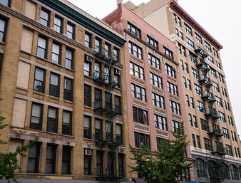 Low angle view of urban apartment buildings with fire escapes