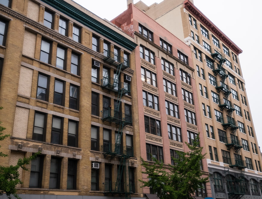 Low angle view of urban apartment buildings with fire escapes