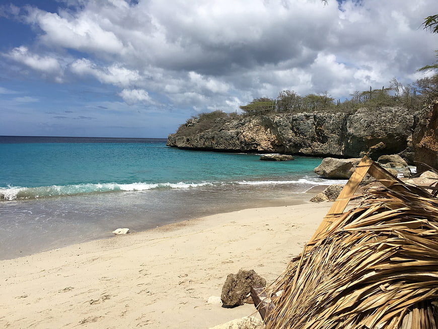 Tropical Beach with Turquoise Water and Rocky Cliffs