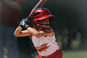 Young Baseball Player in Red Helmet and White Jersey
