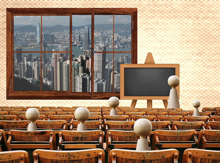 Conceptual classroom with wooden figures and city view