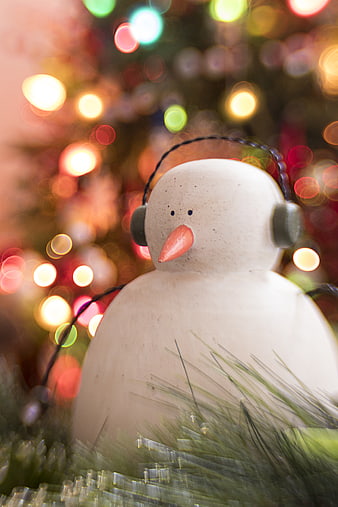 Cute Ceramic Snowman Ornament with Christmas Lights Bokeh Background