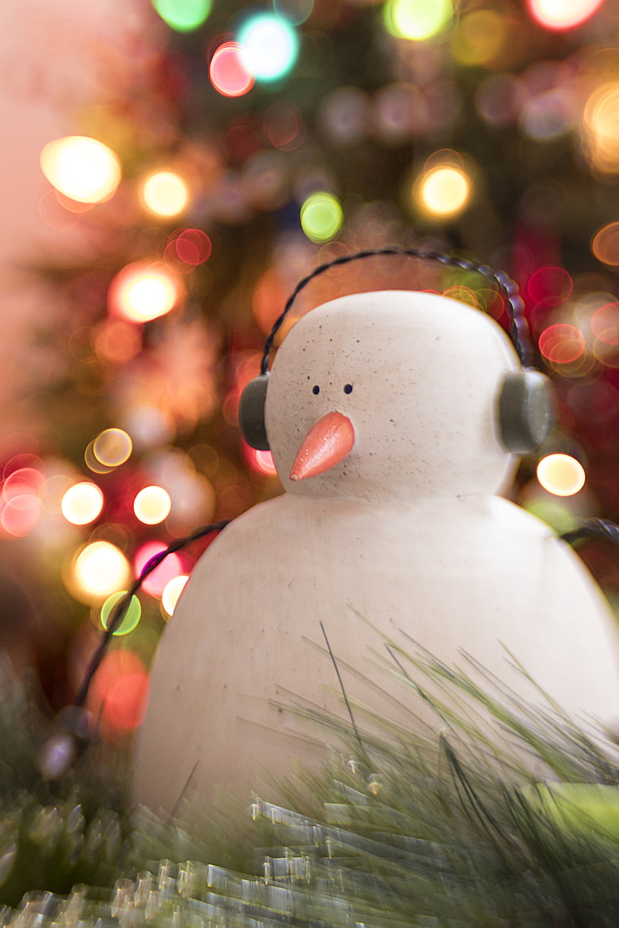 Cute Ceramic Snowman Ornament with Christmas Lights Bokeh Background