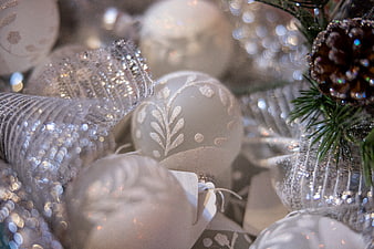 Close-up of white and silver Christmas ornaments with glitter