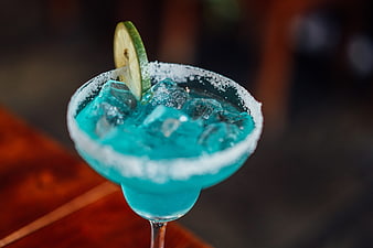 Blue Margarita Cocktail With Salt Rim And Lime Garnish