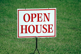 Red and White Open House Sign on Green Lawn