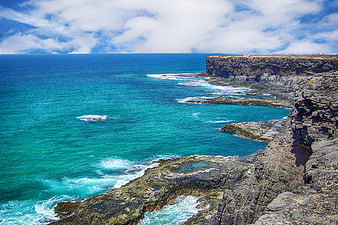Coastal cliffs and turquoise ocean in Fuerteventura, Canary Islands