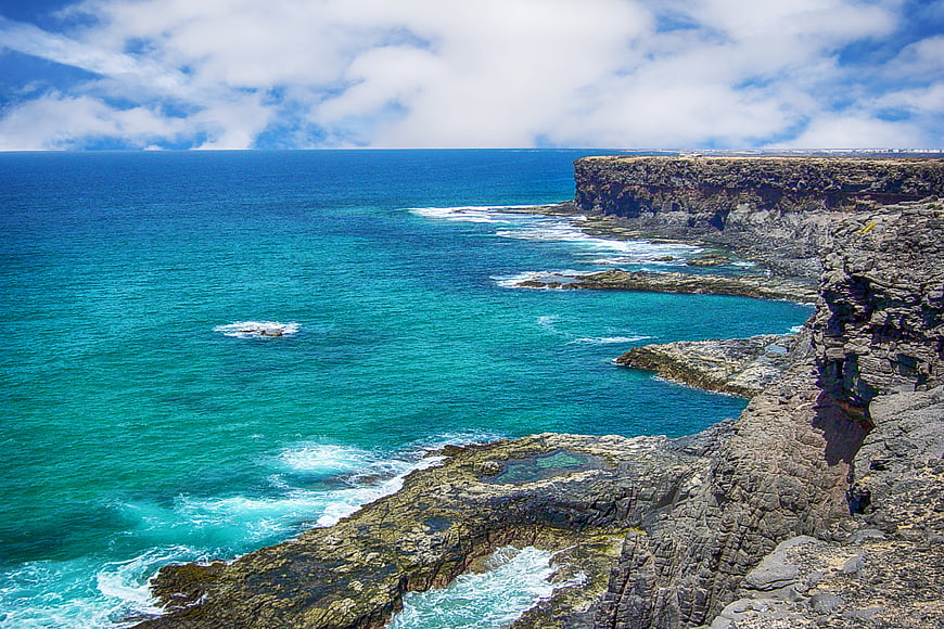Coastal cliffs and turquoise ocean in Fuerteventura, Canary Islands