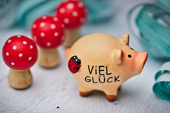 Handmade ceramic pig figurine with Viel Gluck text and red mushroom decorations
