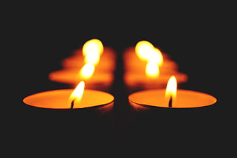 Tealight candles glowing in the dark with soft focus
