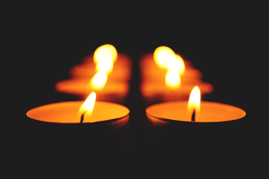 Tealight candles glowing in the dark with soft focus