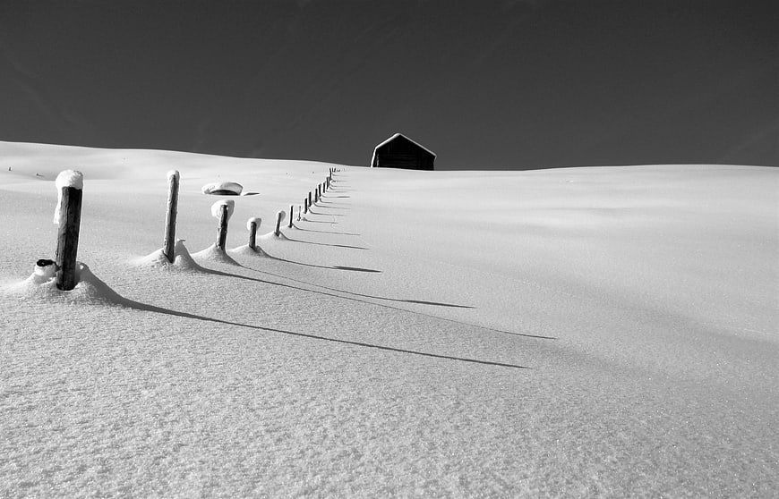 Minimalist Black and White Winter Landscape with Snowy Fence