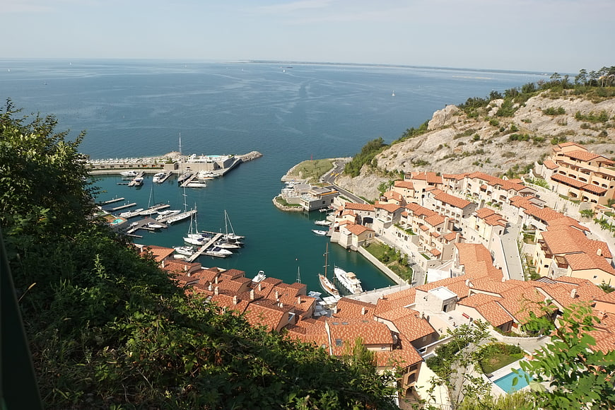 Aerial View of Coastal Town with Marina and Red Roofs
