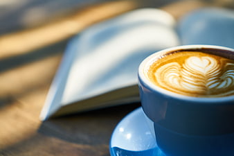 Blue Coffee Cup with Latte Art and Open Book