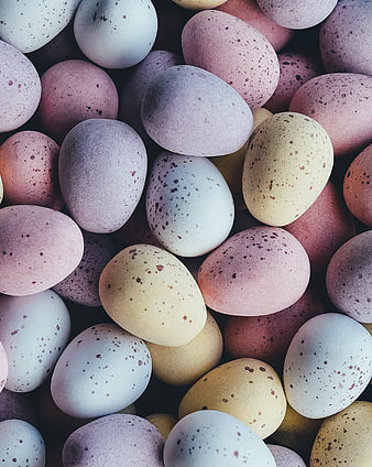 Pastel speckled Easter eggs close up pattern background