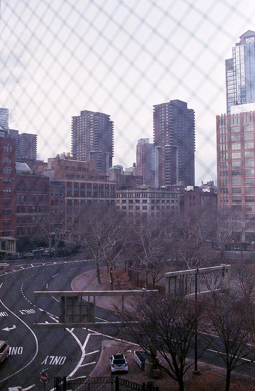 Urban Cityscape View Through Chain Link Fence