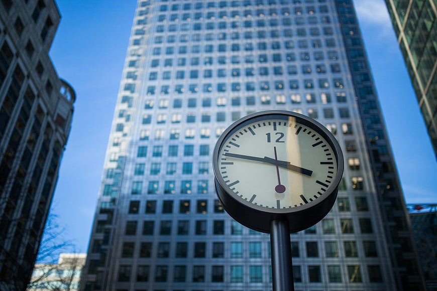 Retro Street Clock in Front of Modern Skyscraper