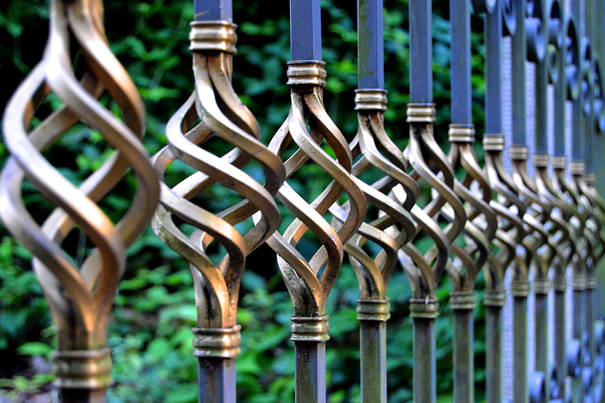 Close-up of ornate wrought iron fence with twisted metal design
