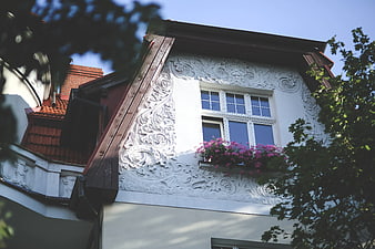Ornate white facade of an old European building with flowers