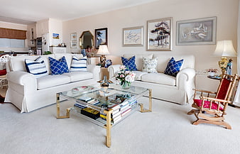 Bright White Living Room With Blue Accent Pillows And Glass Coffee Table