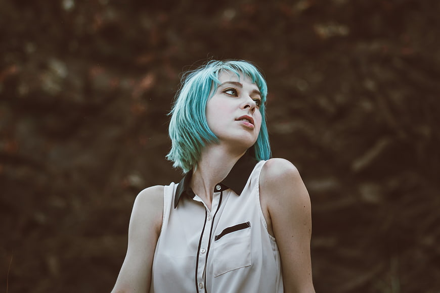 Woman with Blue Hair Looking Up Outdoors