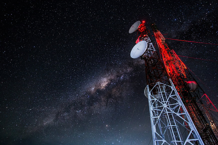 Telecommunication Tower with Satellite Dishes Under Milky Way