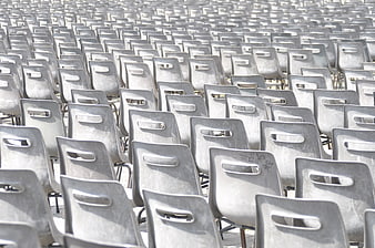 Rows of Empty Gray Plastic Chairs in Outdoor Public Space