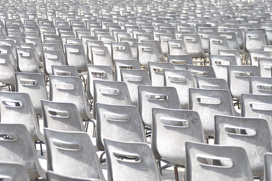 Rows of Empty Gray Plastic Chairs in Outdoor Public Space