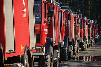 Row of red fire trucks parked in a line