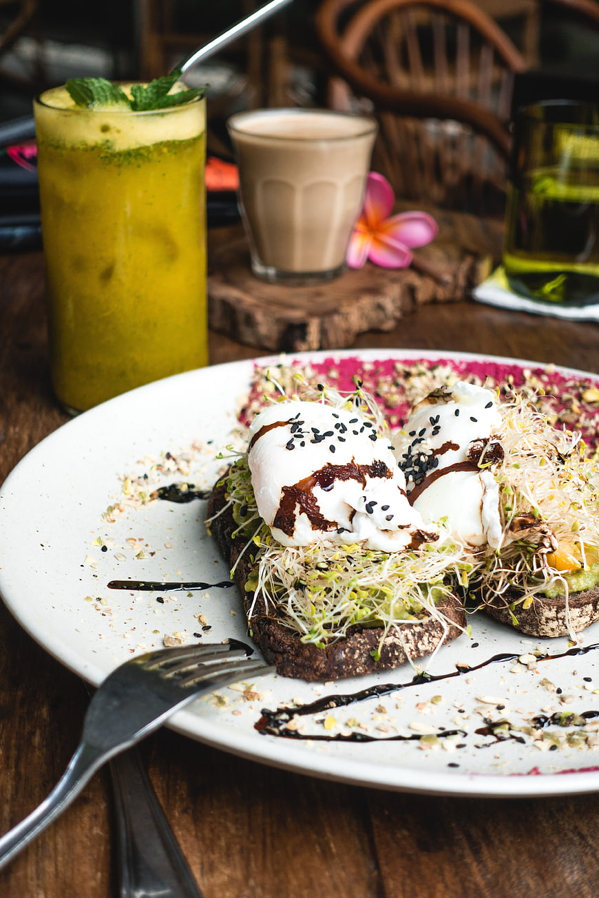 Healthy brunch toast with poached eggs and sprouts
