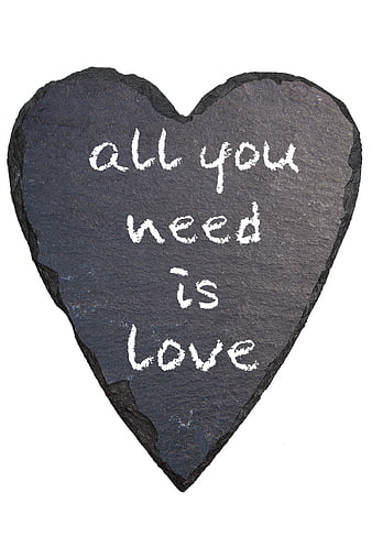 Heart-shaped slate with 'all you need is love' chalk text