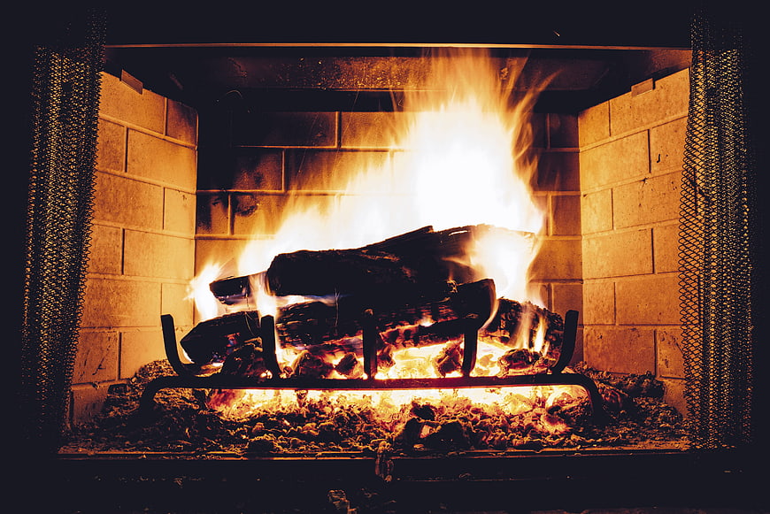Warm crackling fire burning in a brick fireplace