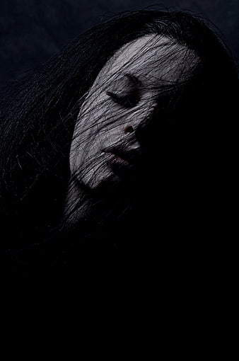 Moody Portrait of Woman With Dark Hair Covering Face
