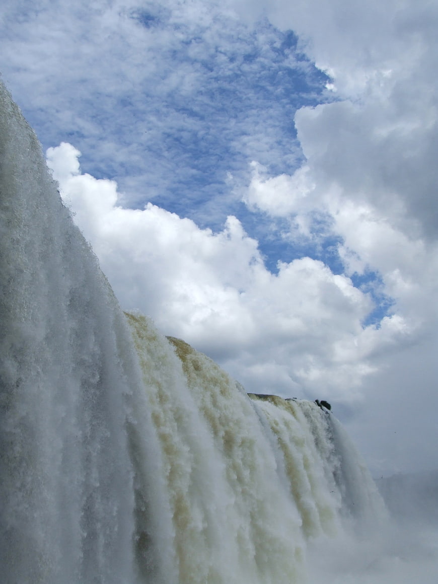 Powerful Iguazu waterfall cascading against blue sky