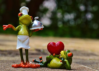 Cute frog figurines with chef hat and heart