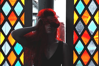 Woman with Red Hair in Front of Stained Glass Window