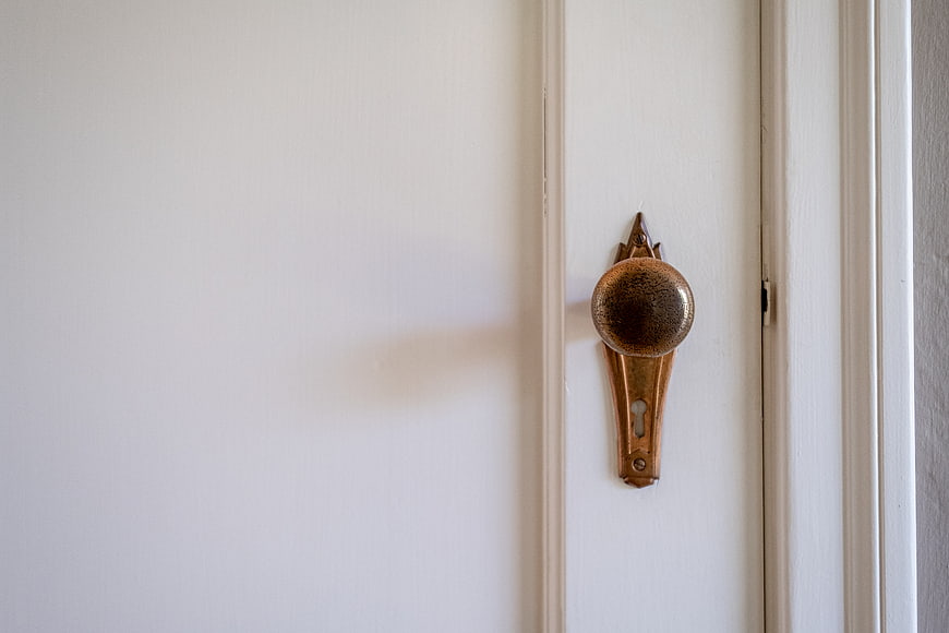 Vintage Brass Door Knob on White Wooden Door